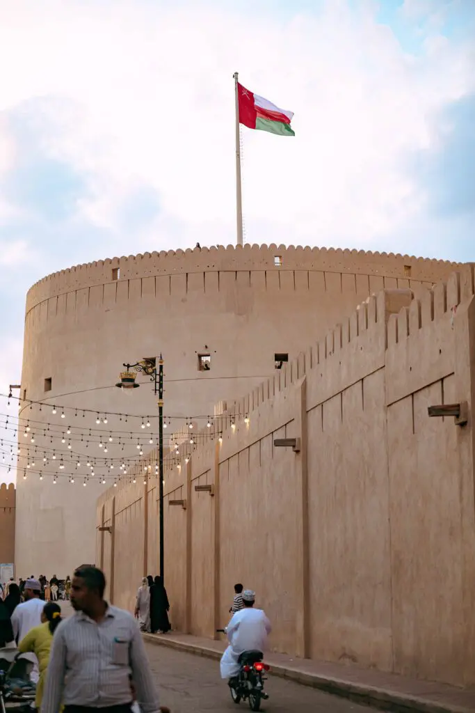 Street in front of Nizwa Fort with passersby
