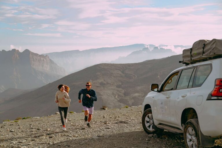 Couple running in the mountains in Oman